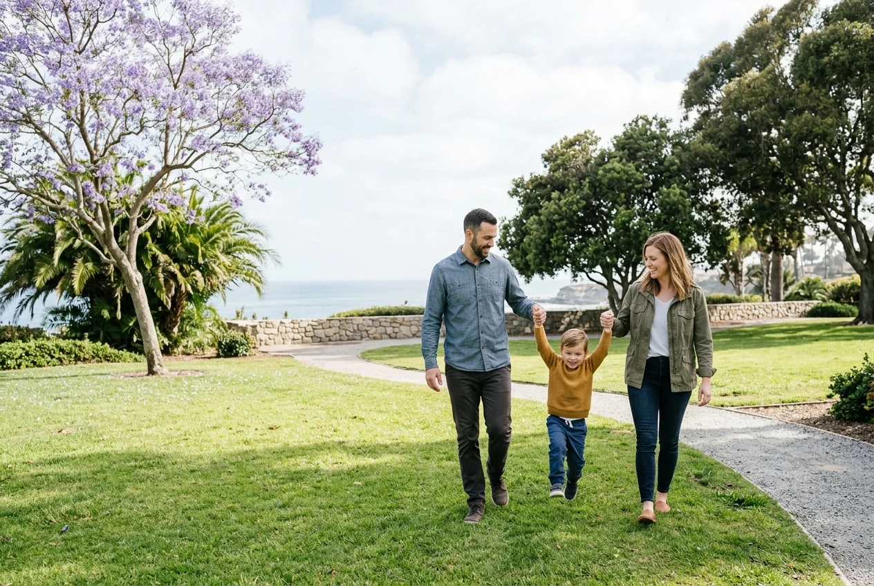 Custom-created scene of parents walking with their child through a coastal park