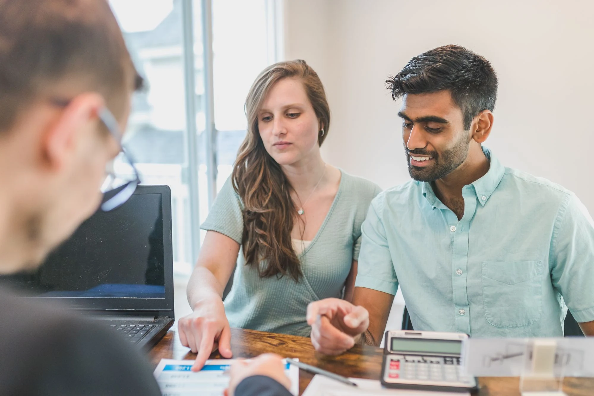 A couple discussing financial plans with an adviser